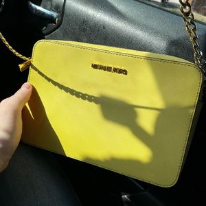 Yellow over the shoulder Michael Kors purse.